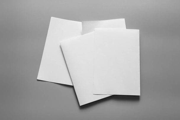 Blank portrait mock-up paper. brochure magazine isolated on gray, changeable background / white paper isolated on gray - Fotó, kép