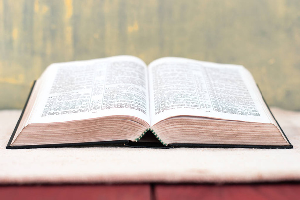 Open Holy Bible on an old table. Beautiful background.Religion concept. - Photo, Image