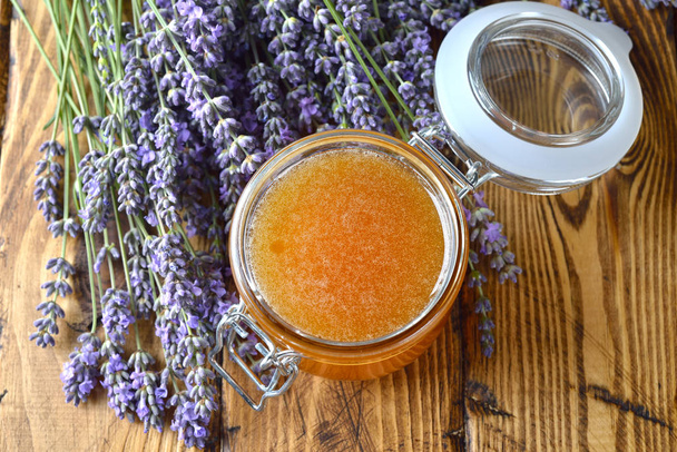 Natural organic lavender honey on a wooden background - Фото, зображення