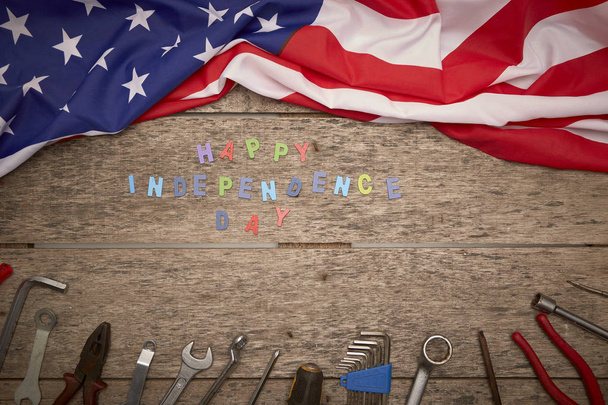 Day of America holidays, flag with tools on an old wooden background, concept of significant days - Фото, зображення