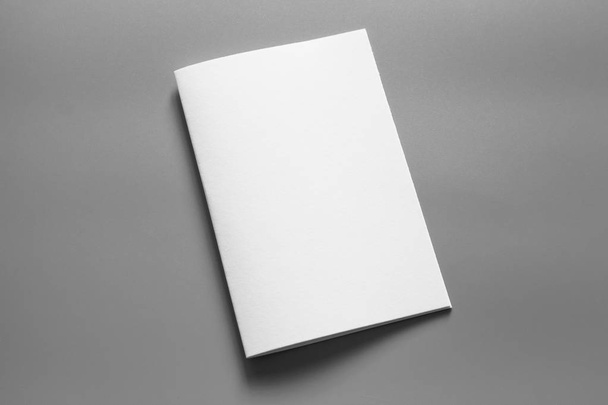Blank portrait mock-up paper. brochure magazine isolated on gray, changeable background / white paper isolated on gray - Foto, Bild