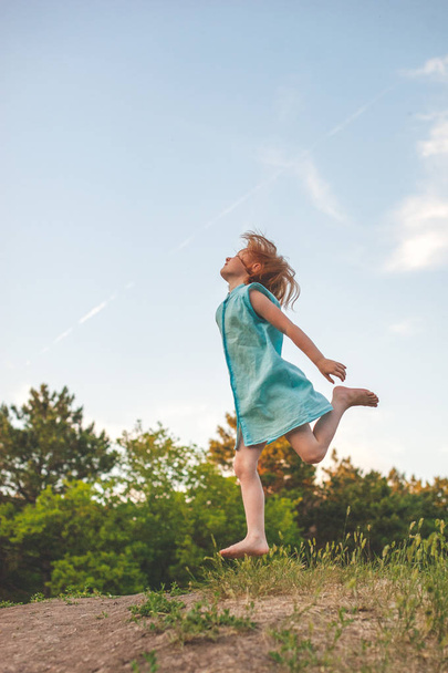The girl jumps high, as if flying - 写真・画像