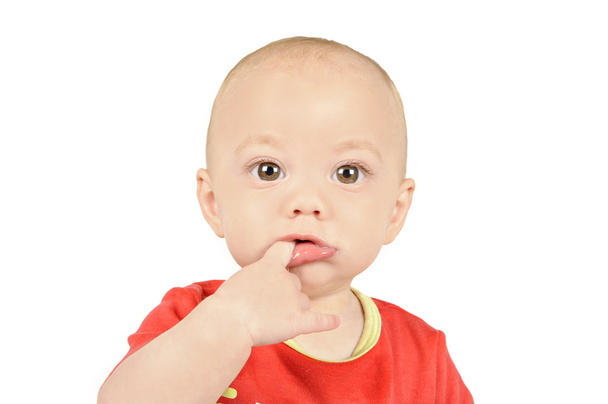 Baby boyin red shirt sucking on his finger - Fotografie, Obrázek