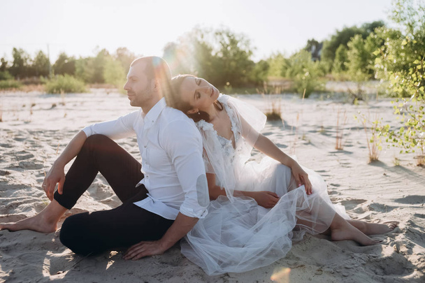 beautiful happy tender couple sitting on beach - Photo, Image