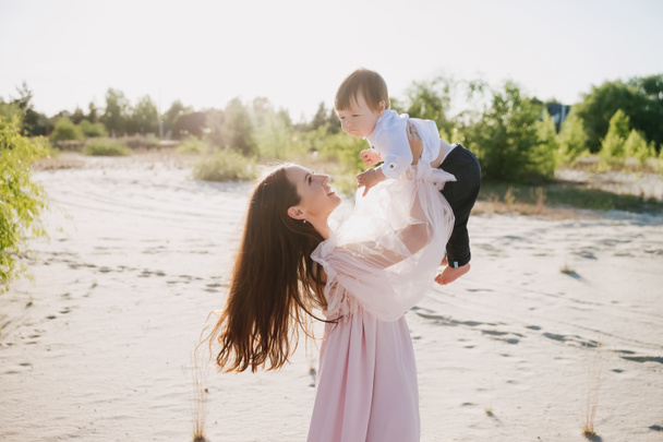 young mother having fun with little son on beach - Photo, Image