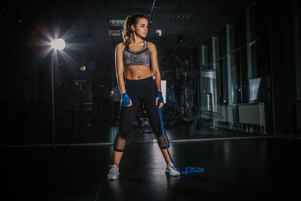young beautiful girl boxer in a dark gym - Photo, Image