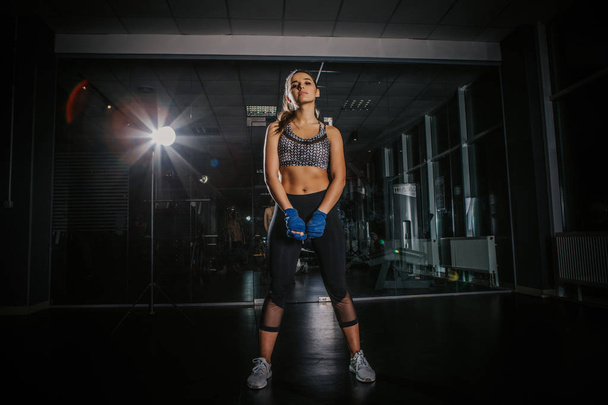 young beautiful girl boxer in a dark gym - Foto, immagini
