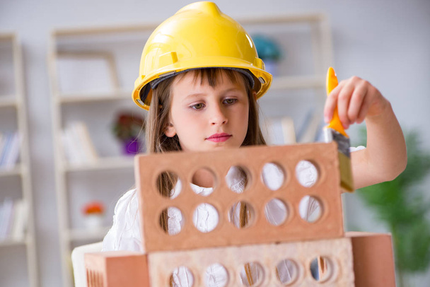 Young girl building with construction bricks - Photo, Image