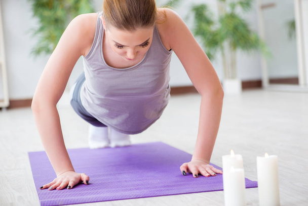 Young woman exercising in sports hall in healthy concept - Photo, Image
