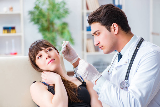 Doctor checking patients ear during medical examination - Photo, image