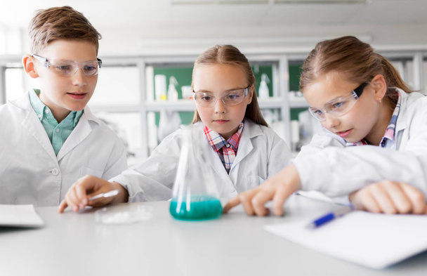 kids with test tube studying chemistry at school - 写真・画像