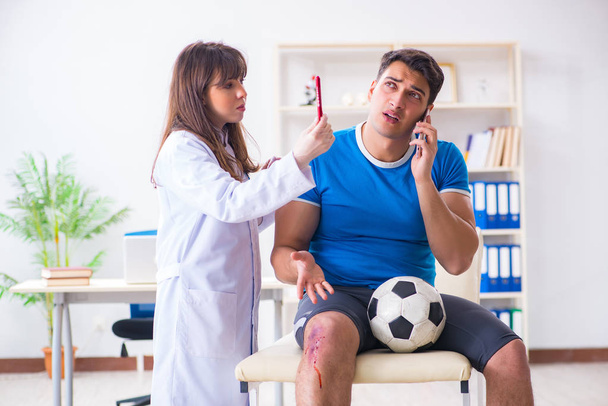 Football soccer player visiting doctor after injury - Photo, Image