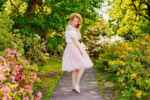Attractive young woman posing outdoors in the garden - 写真・画像