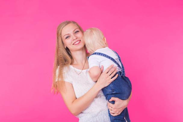 Funny family on pink background. Mother and her daughter girl. Mom and child are having fun. - Fotografie, Obrázek