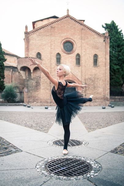 Young beautiful ballerina posing in front of St. Stephen church. - Foto, Imagen
