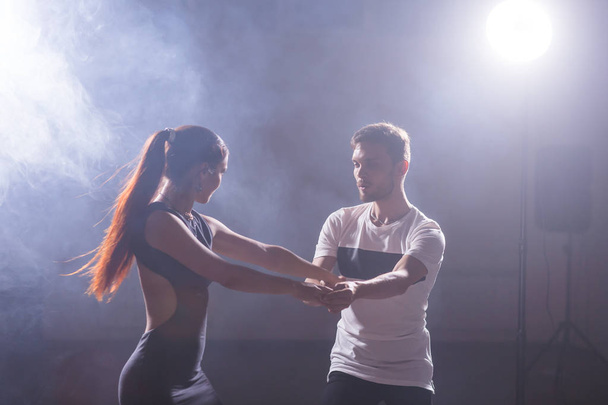 Active happy adults dancing bachata together in dance class - Photo, Image