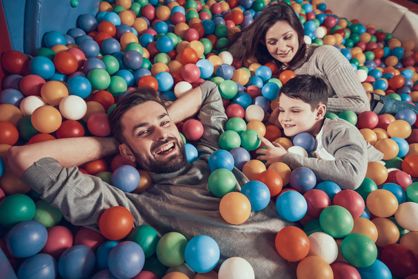 Top view. Happy family lying in pool with balls. Family rest, leisure concept. Spending holiday together. Entertainment center, mall, amusement park. - Foto, Imagem