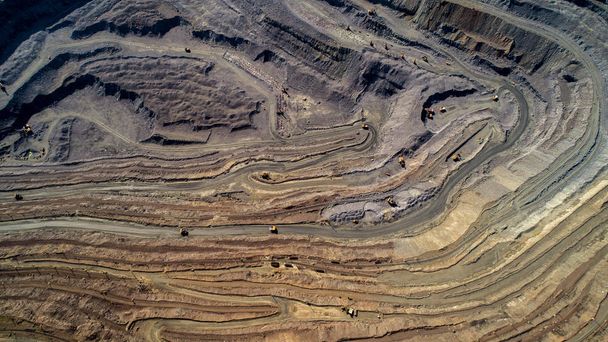 Aerial view of opencast mining quarry with lots of machinery at work. - Photo, Image
