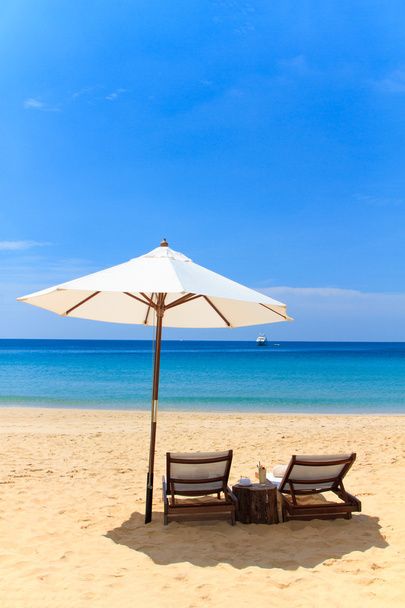 beds and umbrella on a beach - Photo, image