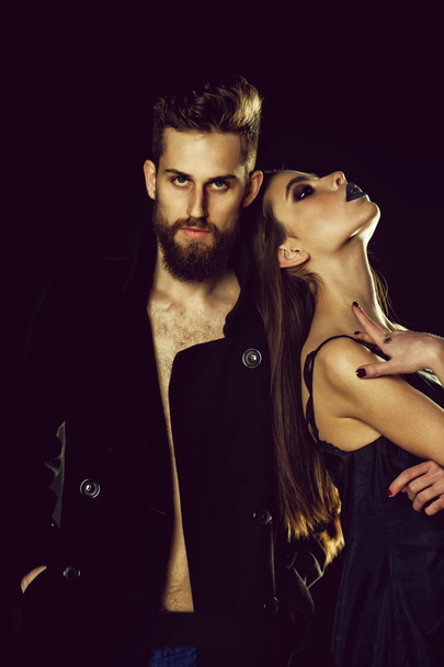 fashionable couple. couple of bearded man, woman in black with fashionable makeup - Foto, afbeelding