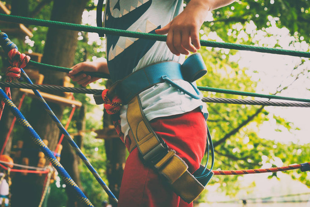 The boy climbs a rope park - Zdjęcie, obraz