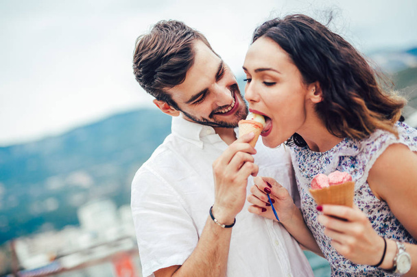Happy couple having date and eating ice cream on vacation. - Photo, Image