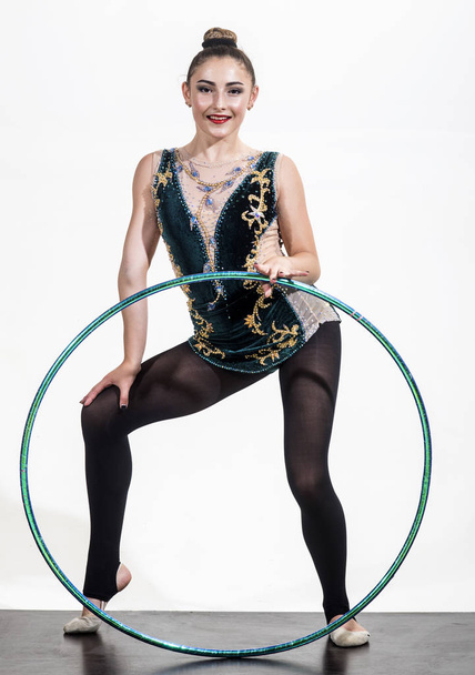 Woman with gymnastic ring. Woman train acrobatics with hula hoop in sportswear. Fitness and dieting of girl gymnast. Workout sports activities in gym of flexible girl. Sport success and health - Foto, afbeelding