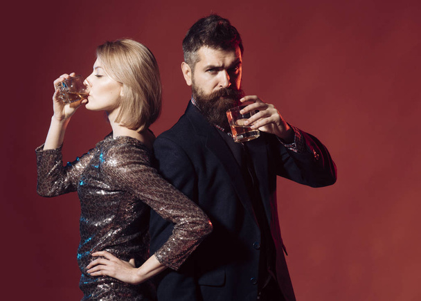 Worst office holiday party stories. Man in suit and fancy lady at corporate party drinking. Celebration with alcohol concept. Man with beard and woman in dress office workers celebrating holiday - Photo, Image
