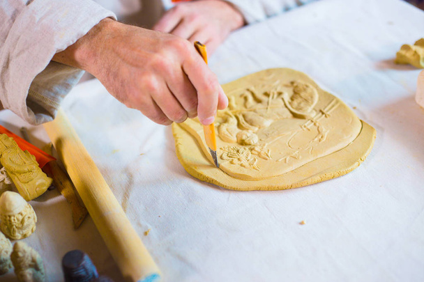 Potter making clay stamp picture - Φωτογραφία, εικόνα