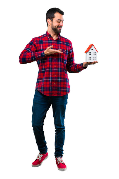Handsome man holding a little house - Foto, Imagem