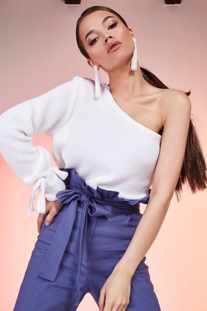 Brunette hair woman beautiful face sexy body shape wear fashion dress silk blouse white color and blue pants runway model studio catalog clothes style for summer vacation walk date beach party makeup. - Foto, Bild