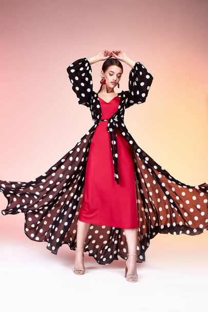 Glamour fashion woman long brunette hair natural evening makeup wear sexy silk long dress polka dot and red stylish from new catalog spring summer collection accessory jewelry earring body shape care. - Foto, Imagem