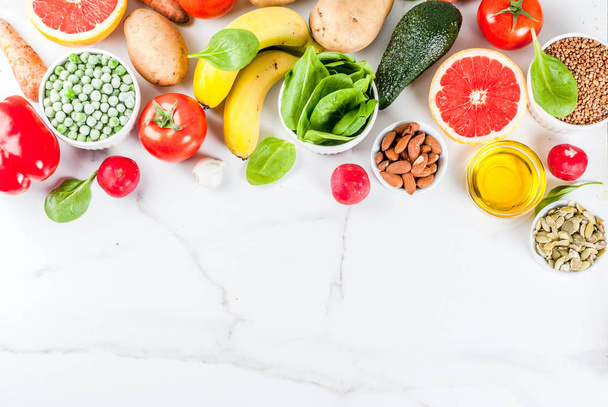 健康食品の背景、トレンディなアルカリ ダイエット商品 - 果物、野菜、穀物、ナッツ。上記のコピー スペース オイル、白大理石の背景 - 写真・画像