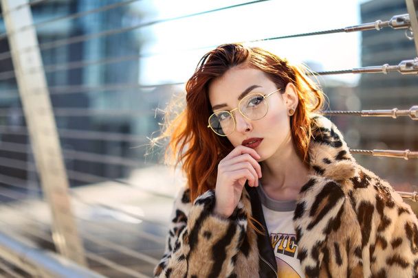 Beautiful red hair young girl in the city with a stylish pose. - Zdjęcie, obraz
