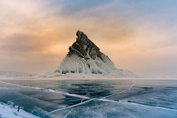 Rock on freeze lake with sunrise sky background, Baikal winter season natural landscape background - Foto, immagini