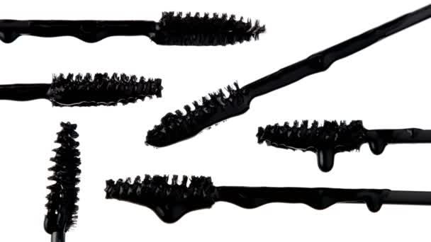 mascara brushes with black liquid pouring on it - Footage, Video