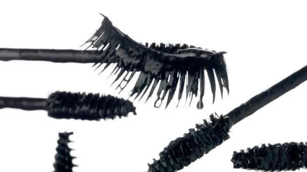 mascara brushes with drops of liquid mascara on it and a falce lashes - Footage, Video