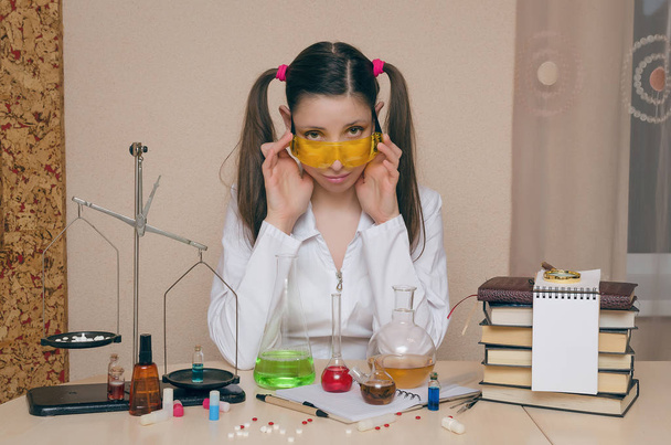 Emotional student girl on chemistry lesson. Pharmacist or apothecary woman. Scientific experiment background. Funny intern in chemical laboratory concept. - Foto, immagini