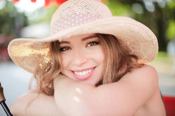 Smiling young teenager with straw hat on a summer day. - Photo, Image