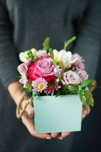 nice bouquet in the hands of woman  - Zdjęcie, obraz