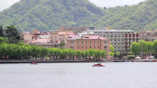 Scenic Italian Village Of Big Mountain Lake and people float on pedalo, Como - Footage, Video