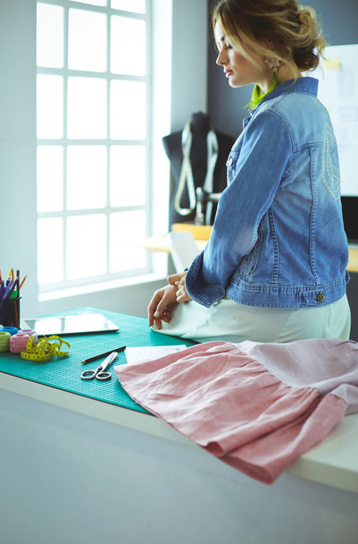 Fashion designer woman working on her designs in the studio - Фото, изображение