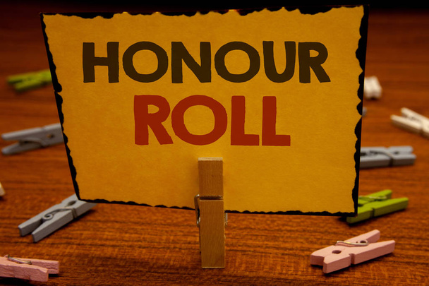 Words writing texts Honour Roll. Business concept for List of students who have earned grades above a specific averageClothespin hold holding Yellow paper ideas clothespins wooden background - Photo, Image