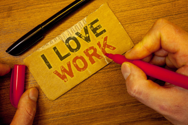Writing note showing  I Love Work. Business photo showcasing To be happy satisfied with job Be doing what you most likeMan creating on yellow paper Hand holding red black pens wooden table - Photo, Image