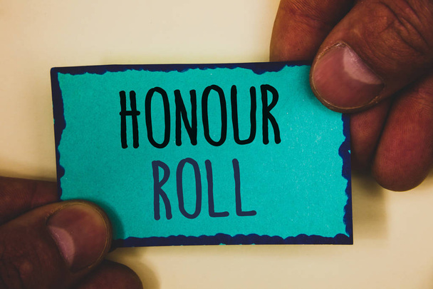 Слова написания текстов Honour Roll. Business concept for List of students who have earned grades above a specific averageMan hold turquoise note black letters and frame beige background
 - Фото, изображение