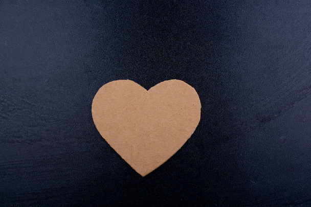 Heart shaped object on a wooden black background - Zdjęcie, obraz