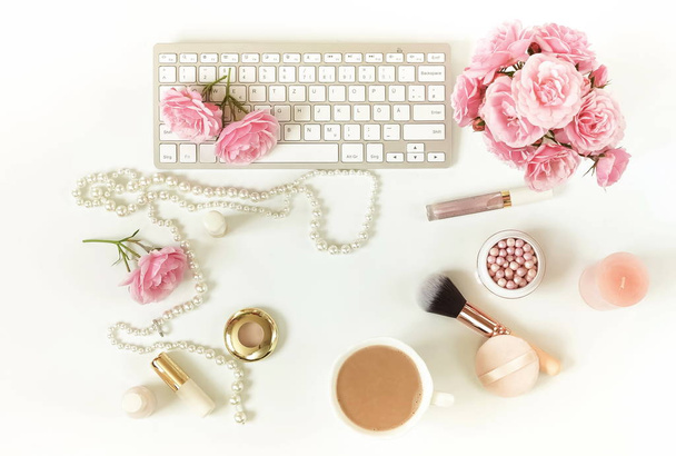 Flat lay, top view office feminine desk, female make up accessories, workspace with laptop and bouquet roses.Beauty blog concept.Copy space - Zdjęcie, obraz