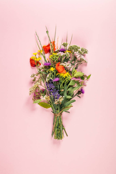 Wild flower bouquet on pastel color background. Top view, flat lay - Φωτογραφία, εικόνα