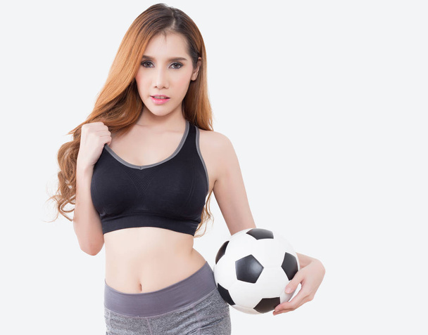 Young sexy woman in sports ware with soccer ball isolated on white background - Photo, Image