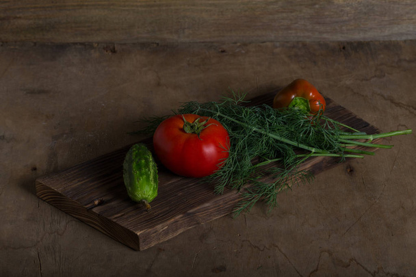 Fresh vegetables on a wooden burned rustic texture for background. Rough weathered wooden board. - Foto, afbeelding